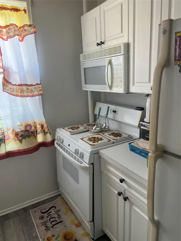 a kitchen with stainless steel appliances granite countertop a stove and a microwave