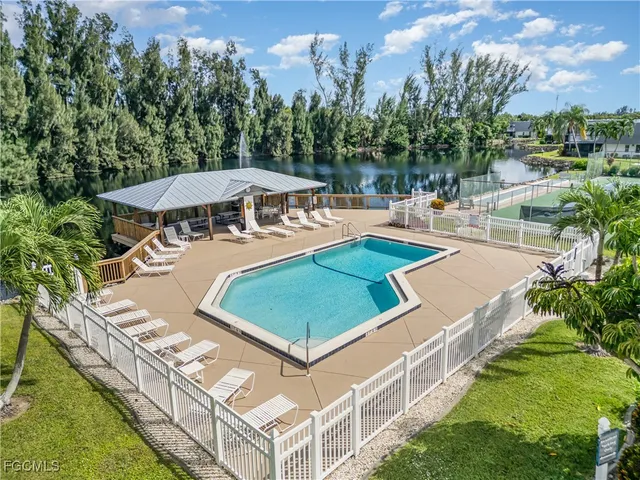 an aerial view of a house with swimming pool patio and outdoor seating
