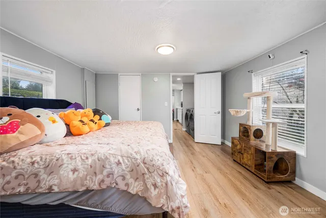 a bedroom with a bed and wooden floor