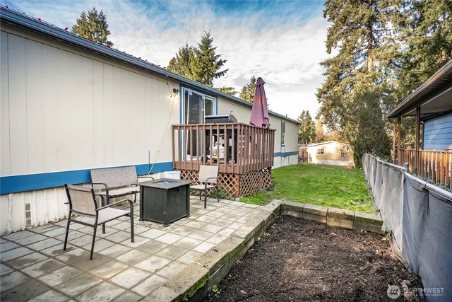 a view of a patio with couches table and chairs and potted plants
