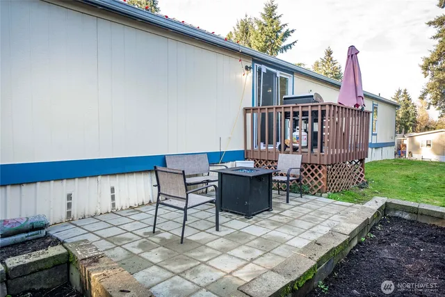 a view of a patio with table and chairs with wooden fence and plants