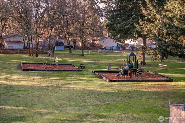 a view of a park with swings and slides