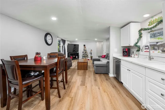 a living room with furniture and kitchen view