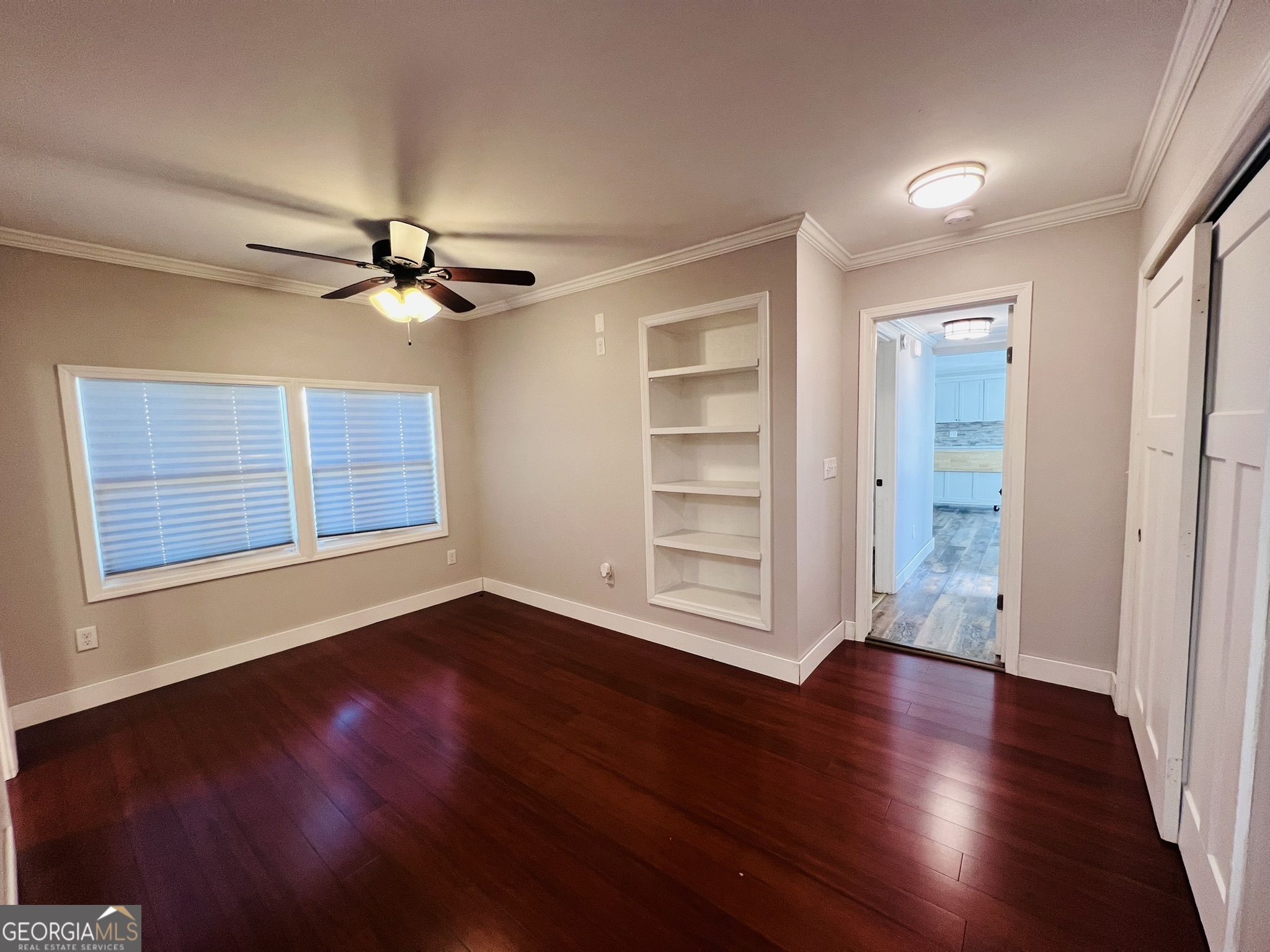 145 Sycamore Street Jesup, GA 31545 - Photo 11 of 14 wooden floor in an empty room with a window