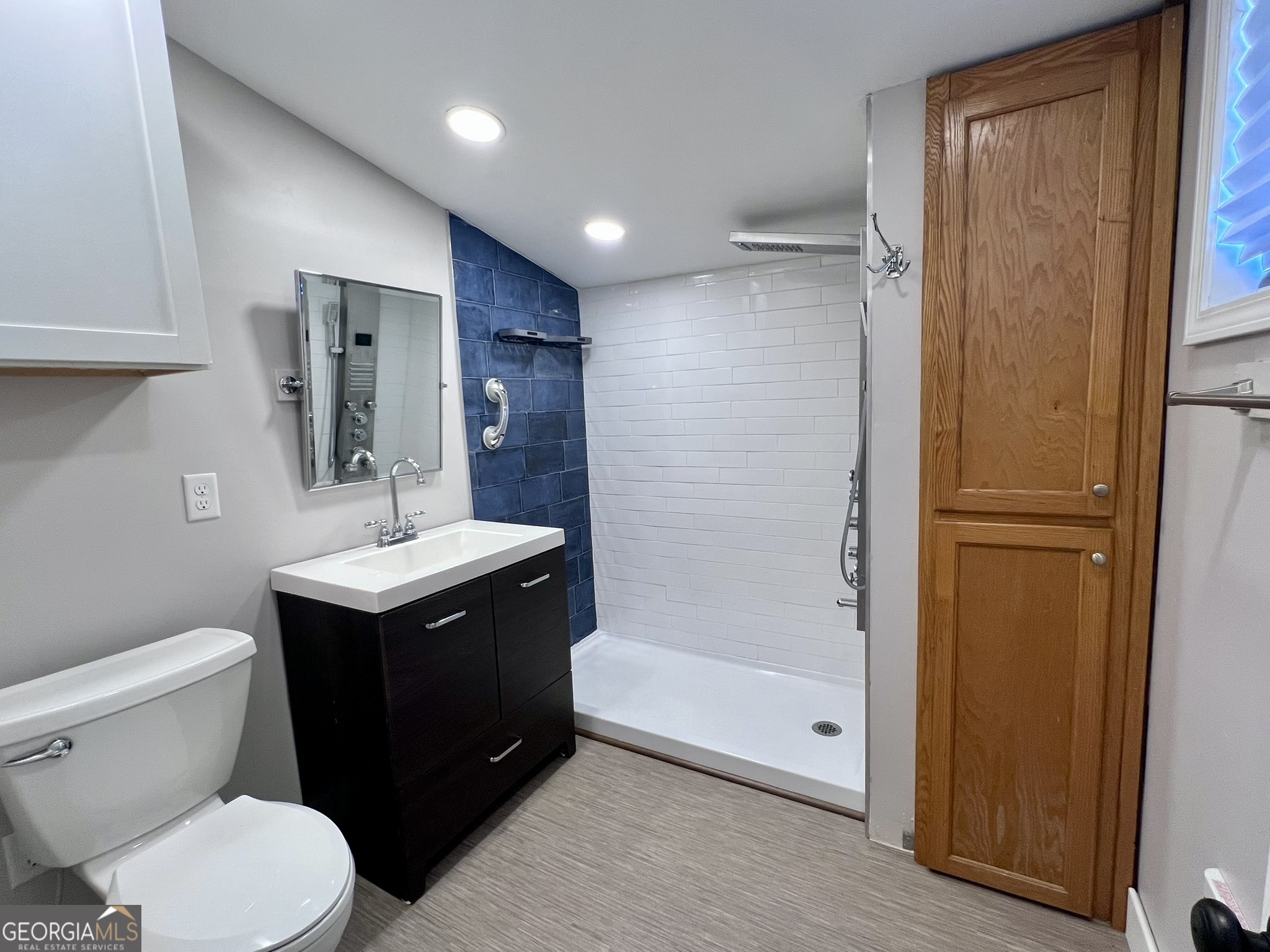 145 Sycamore Street Jesup, GA 31545 - Photo 12 of 14 a bathroom with a toilet a sink and mirror