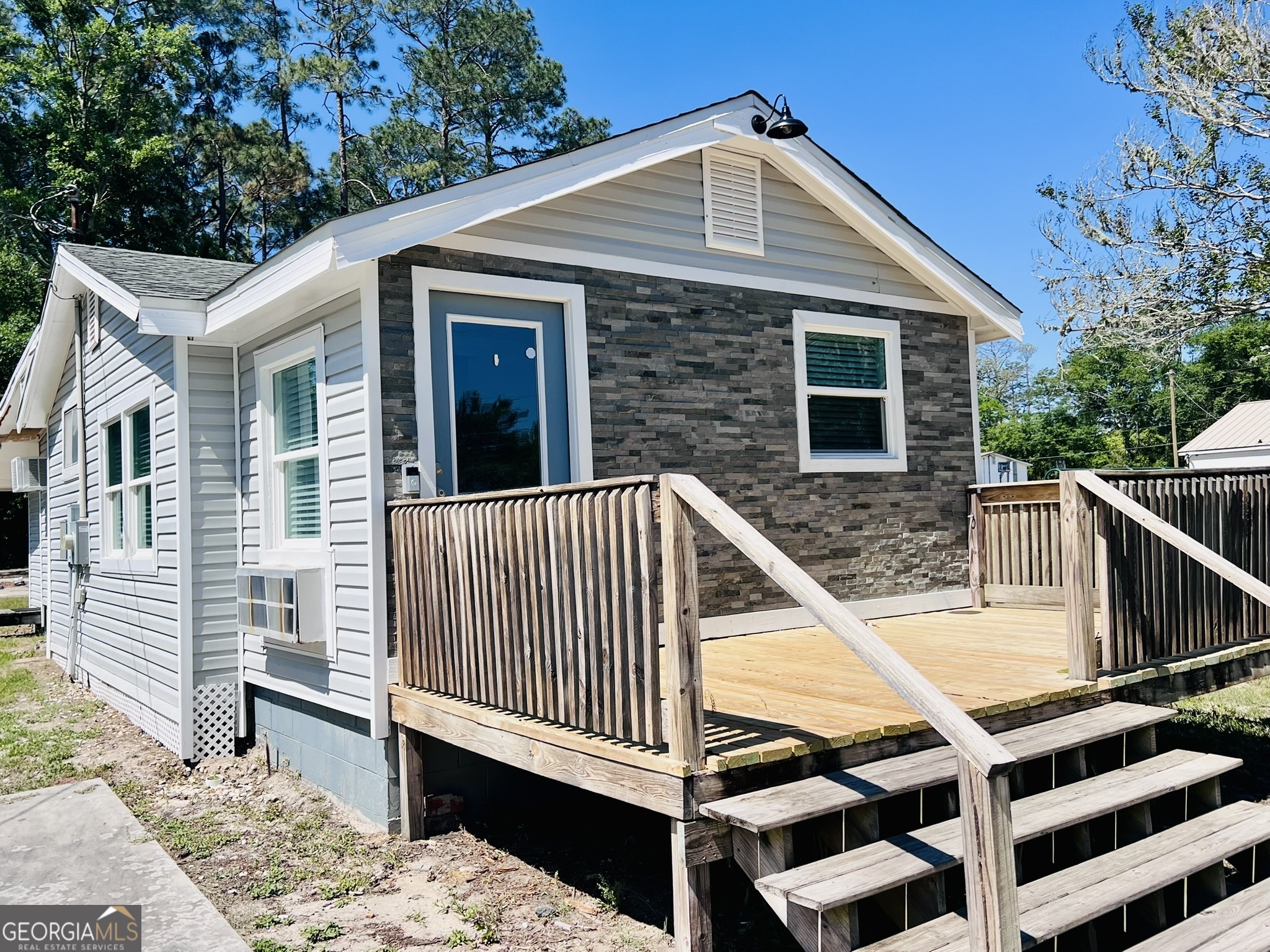 145 Sycamore Street Jesup, GA 31545 - Photo 3 of 14 a view of a house with wooden deck and furniture