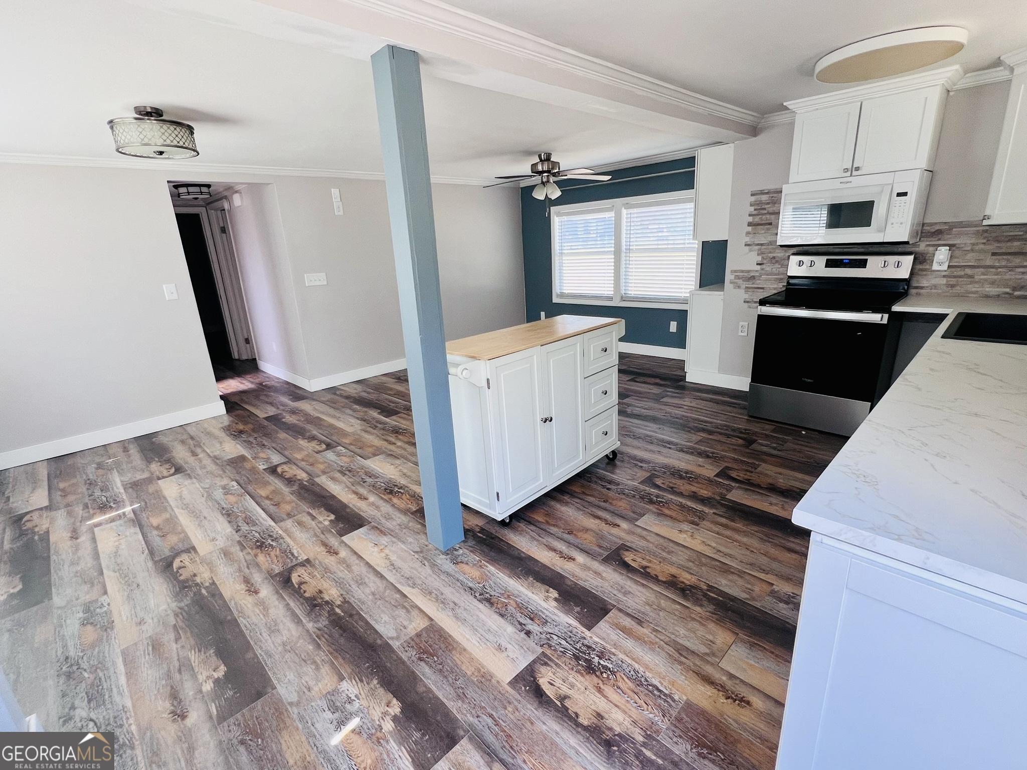 145 Sycamore Street Jesup, GA 31545 - Photo 6 of 14 a kitchen view with wooden floor and electronic appliances