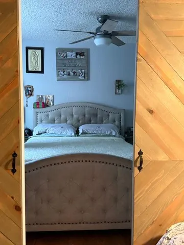 a bathroom with a granite countertop sink a mirror and shower