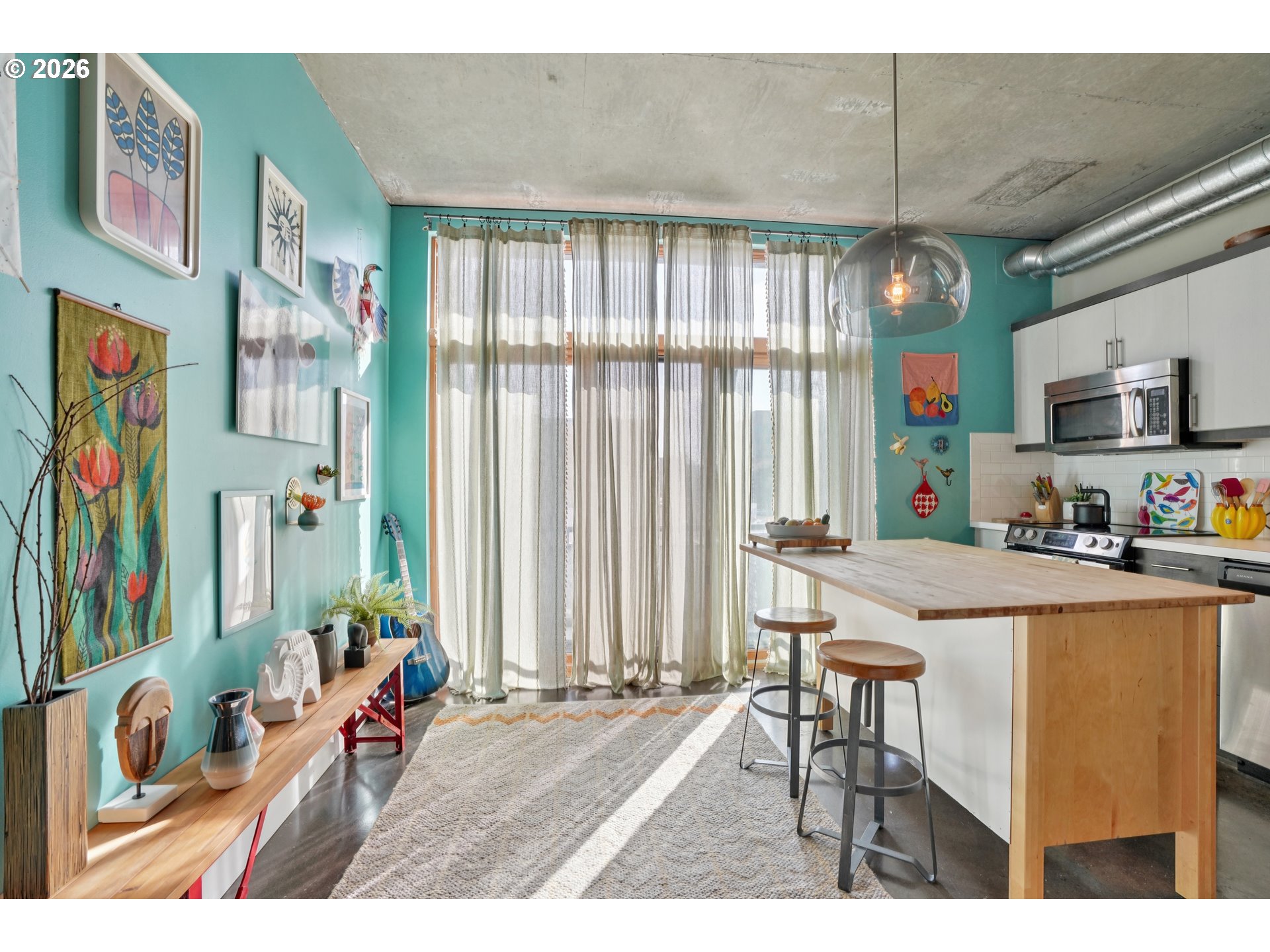 411 Northwest Flanders Street, Unit 302 Portland, OR 97209 - Photo 14 of 41 a open kitchen with stainless steel appliances kitchen island granite countertop a refrigerator and a sink