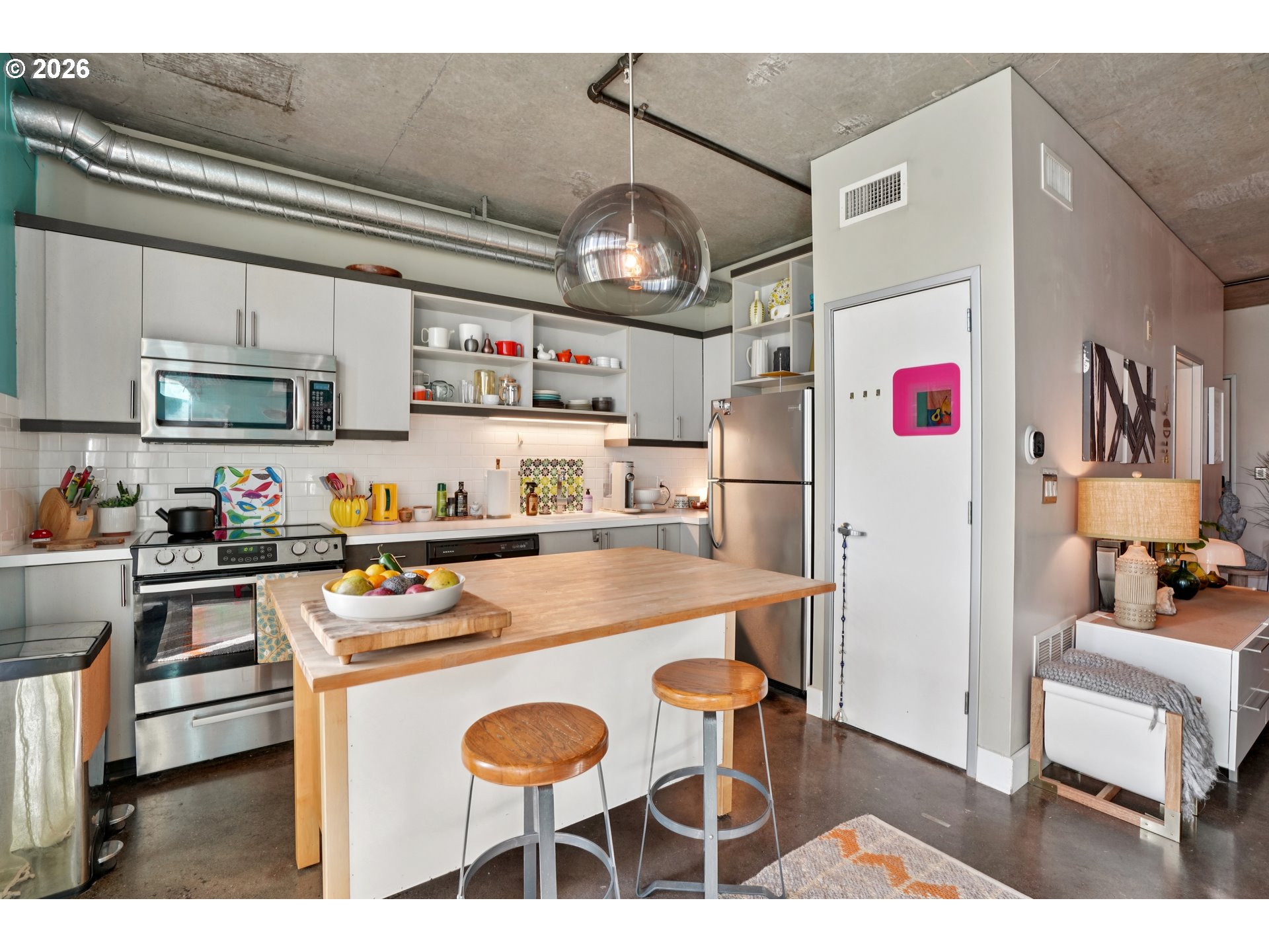 411 Northwest Flanders Street, Unit 302 Portland, OR 97209 - Photo 16 of 41 a kitchen with stainless steel appliances granite countertop a sink refrigerator and cabinets