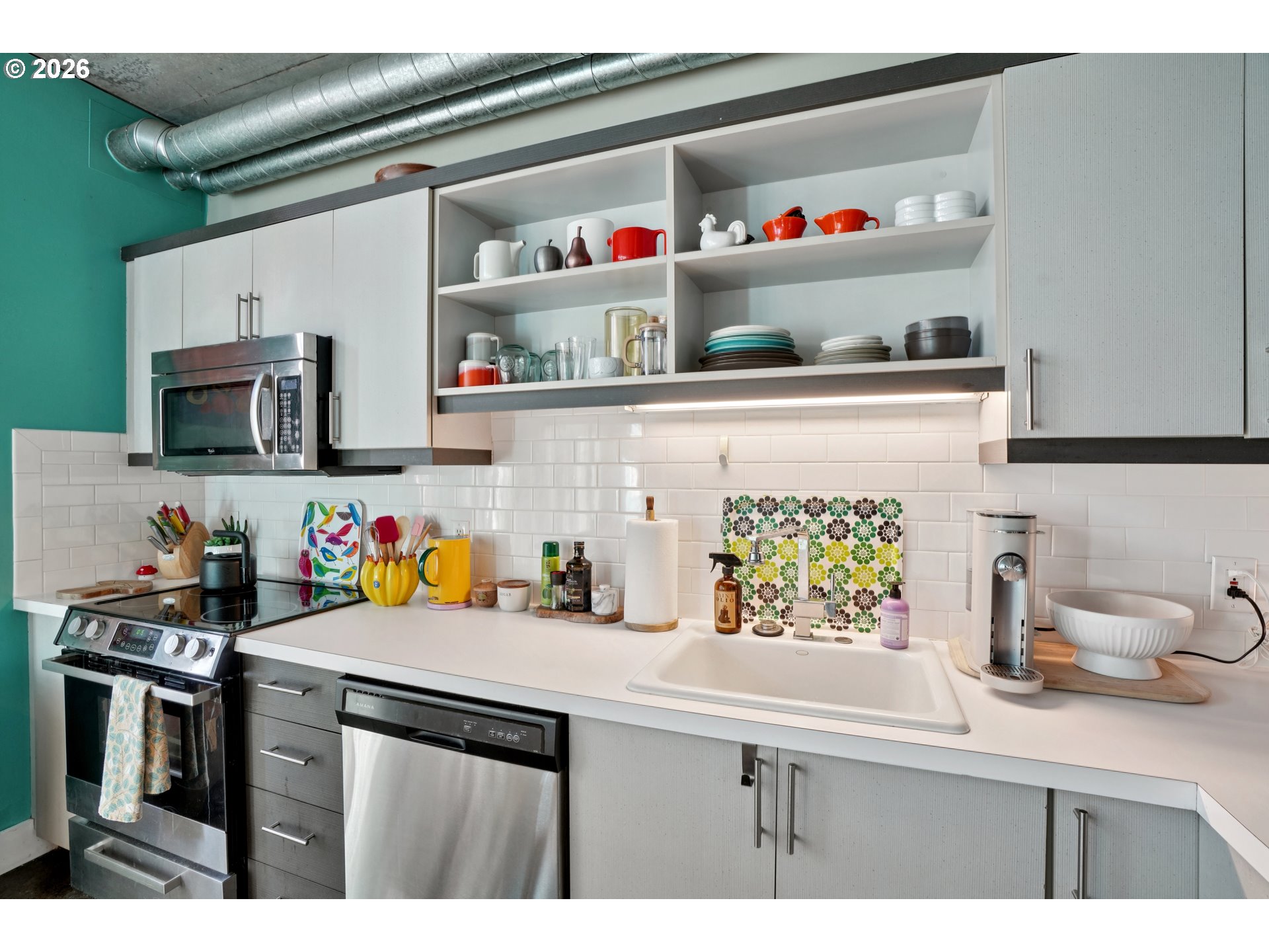 411 Northwest Flanders Street, Unit 302 Portland, OR 97209 - Photo 17 of 41 a kitchen with stainless steel appliances a sink and cabinets