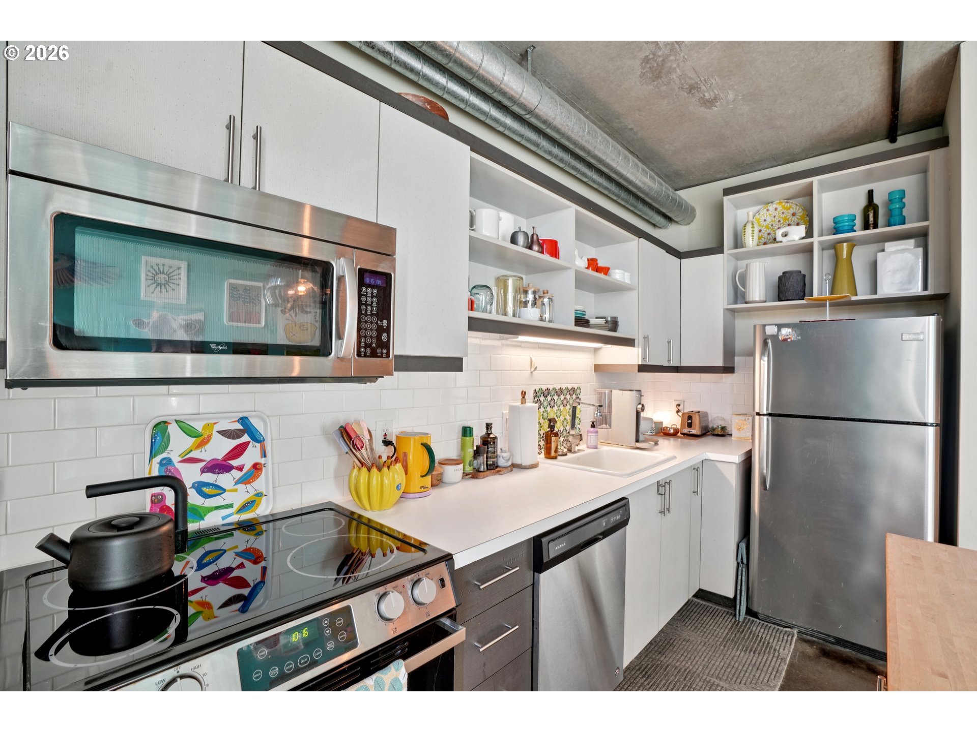 411 Northwest Flanders Street, Unit 302 Portland, OR 97209 - Photo 18 of 41 a kitchen with stainless steel appliances a sink a stove and a microwave