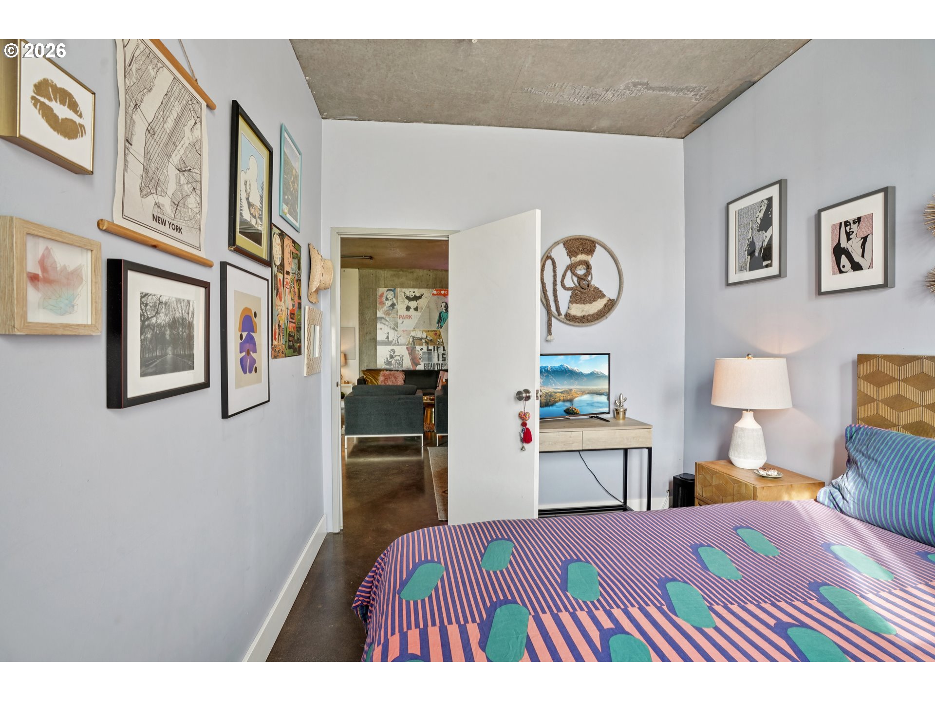 411 Northwest Flanders Street, Unit 302 Portland, OR 97209 - Photo 21 of 41 a bedroom with a bed and wooden floor
