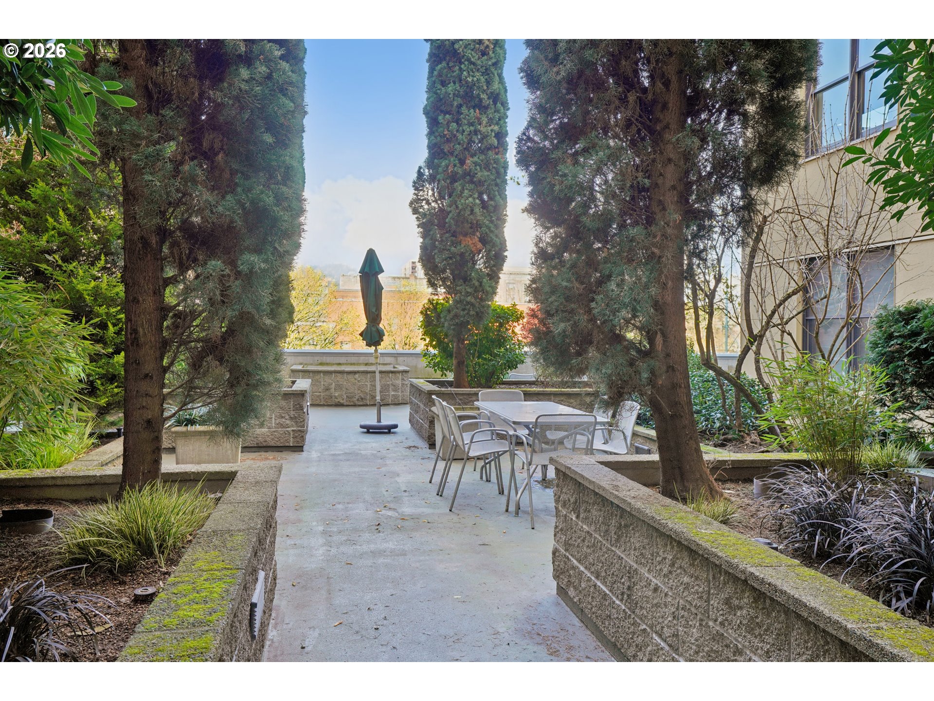 411 Northwest Flanders Street, Unit 302 Portland, OR 97209 - Photo 36 of 41 a view of a patio with table and chairs and potted plants
