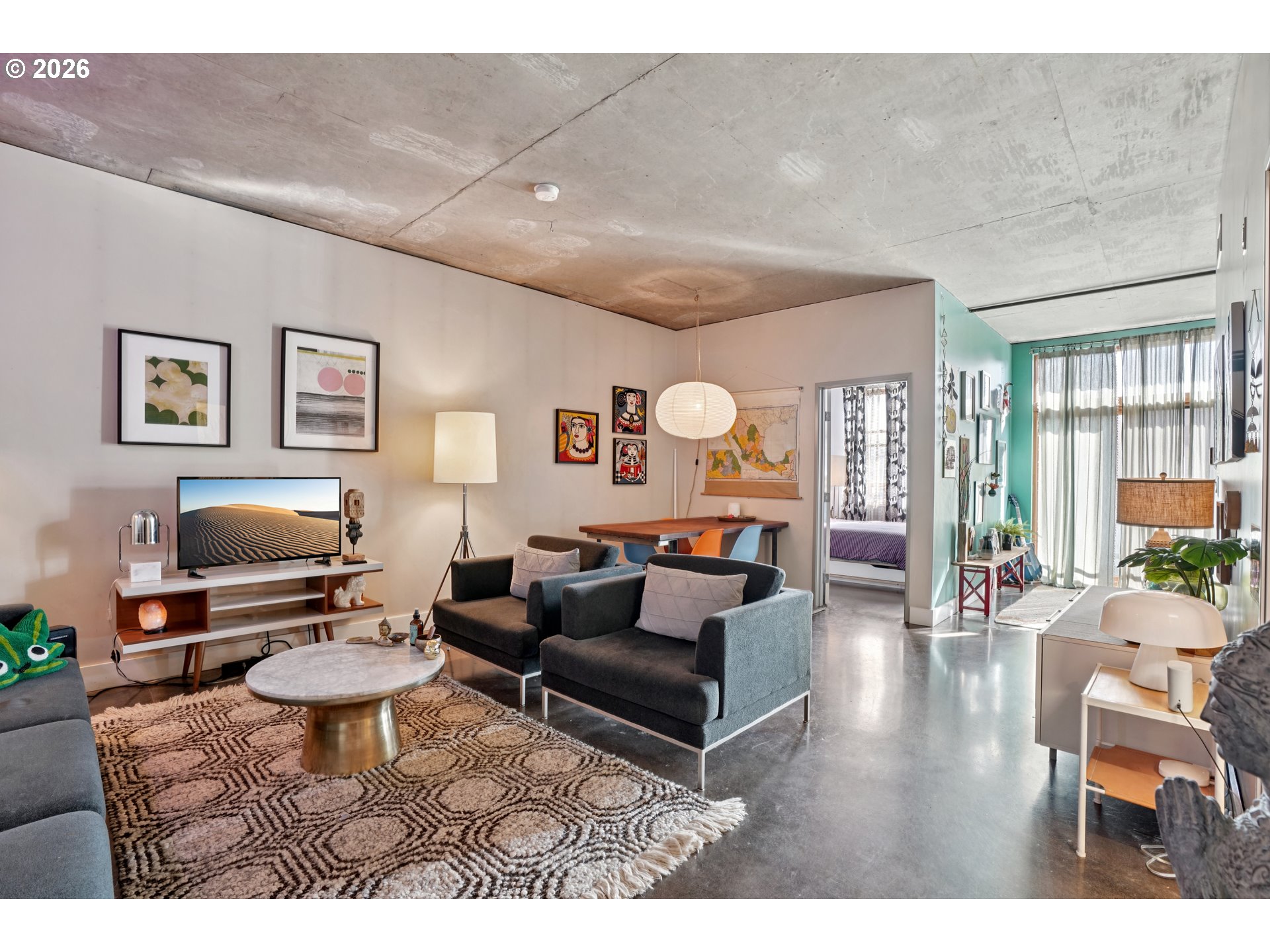 411 Northwest Flanders Street, Unit 302 Portland, OR 97209 - Photo 7 of 41 a living room with furniture a large window and a fireplace
