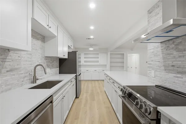 a kitchen with a sink stove and cabinets
