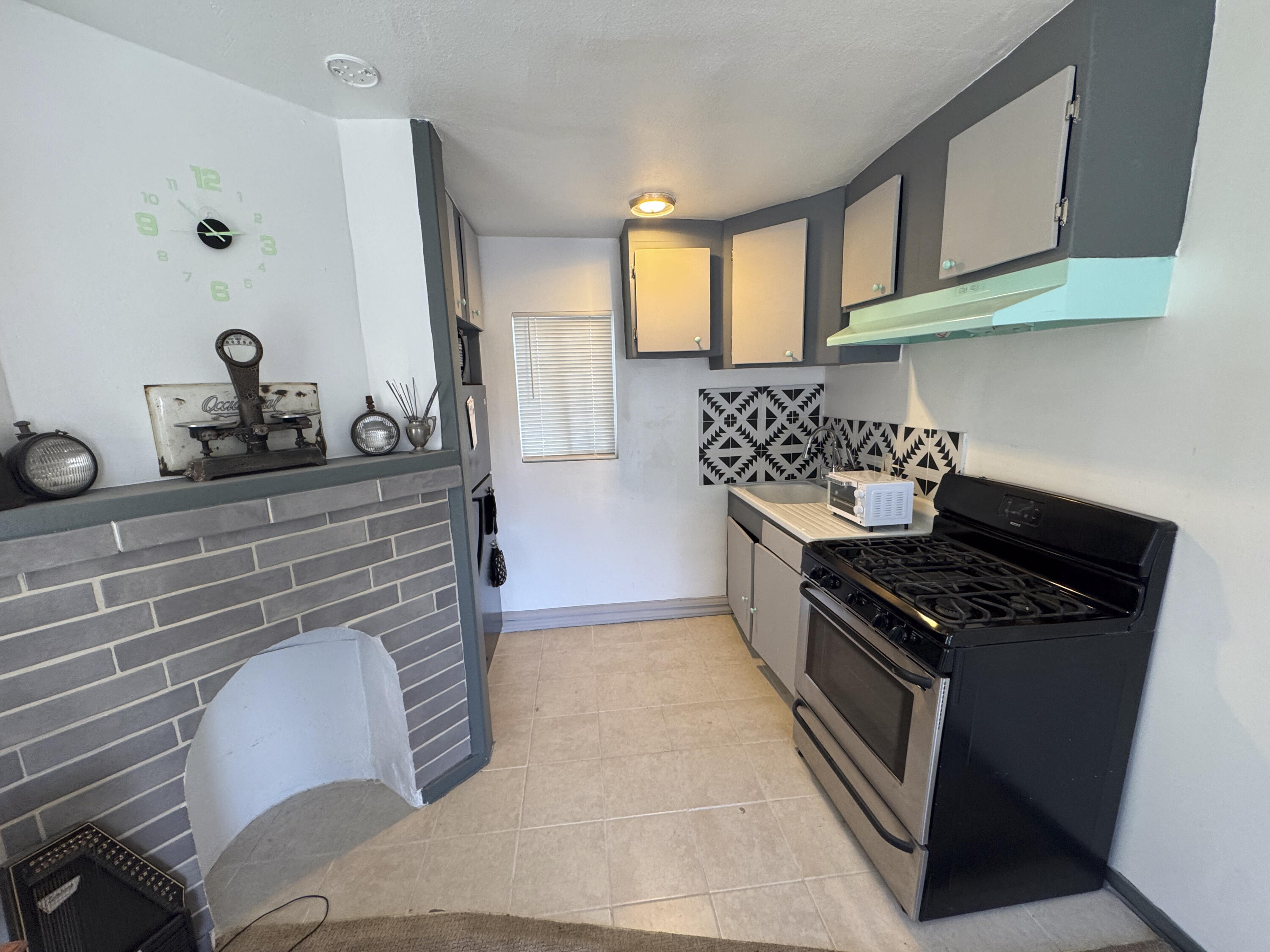 6746 Adobe Road, Unit 13 Twentynine Palms, CA 92277 - Photo 2 of 5 a kitchen with granite countertop a stove and a sink