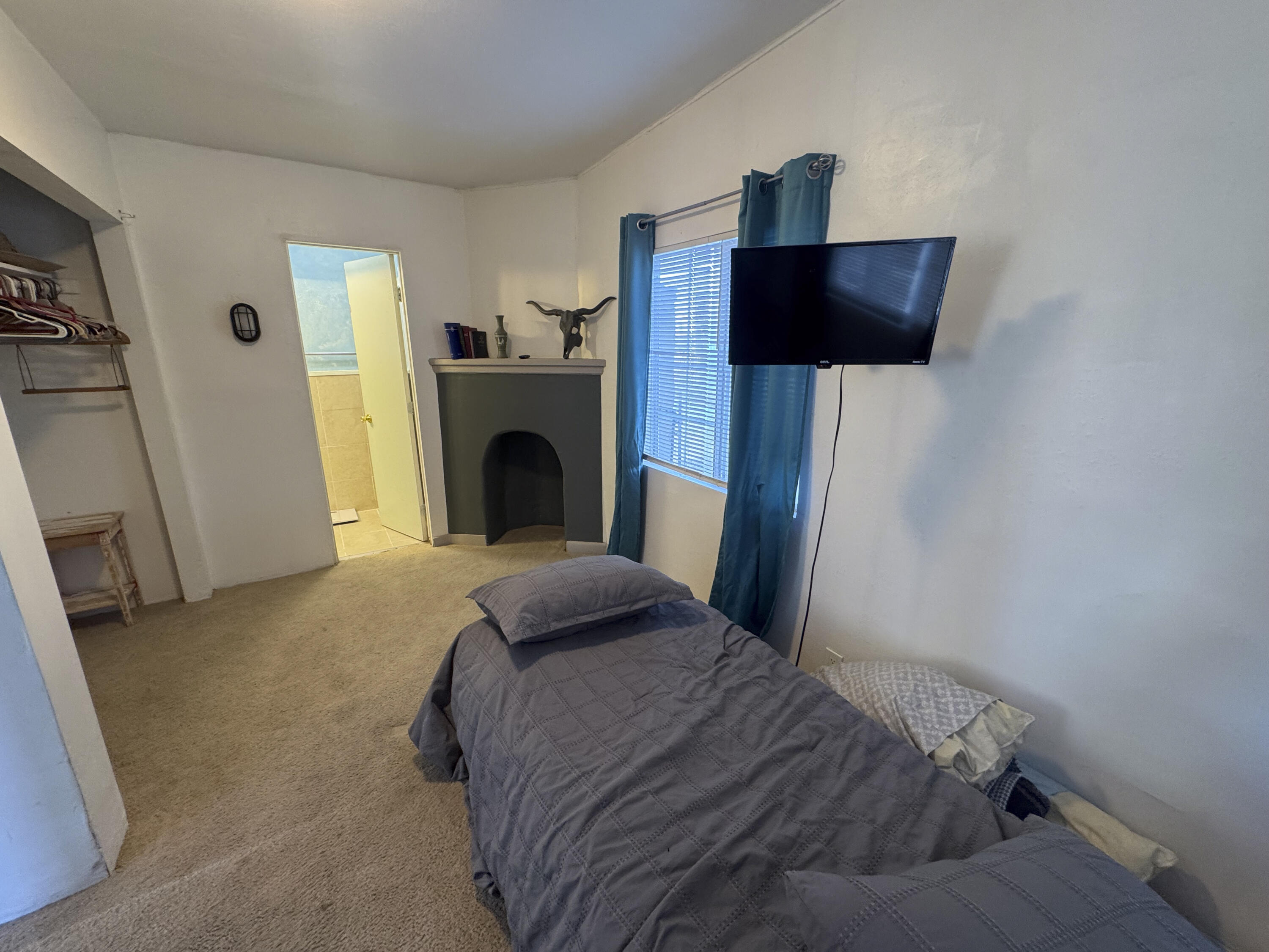 6746 Adobe Road, Unit 13 Twentynine Palms, CA 92277 - Photo 4 of 5 a bedroom with a bed and a television