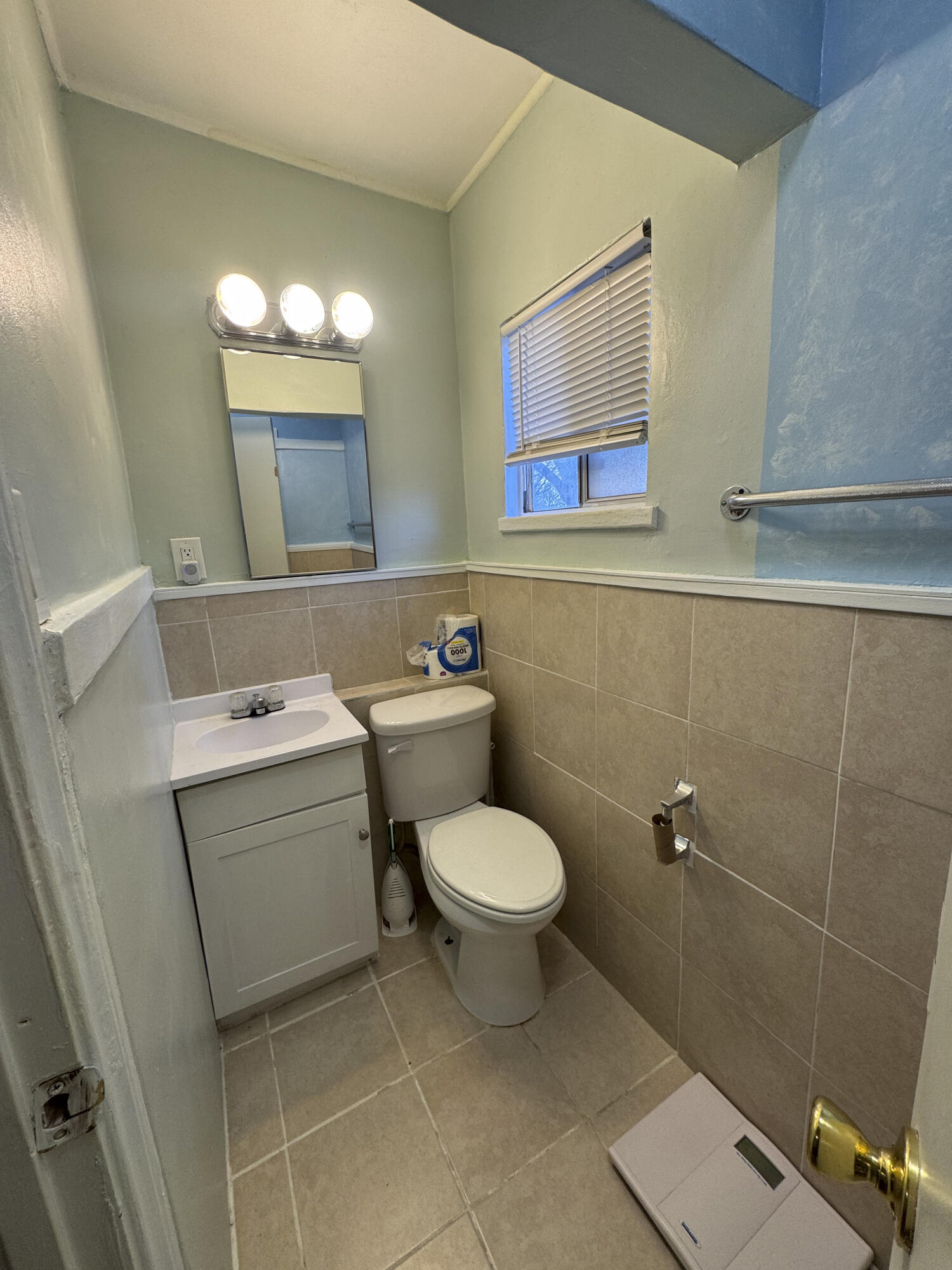 6746 Adobe Road, Unit 13 Twentynine Palms, CA 92277 - Photo 5 of 5 a bathroom with a toilet sink and mirror