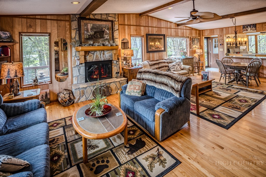 103-105 Upper Grouse Ridge Road Beech Mountain, NC 28604 - Photo 18 of 48 a living room with furniture and a fireplace