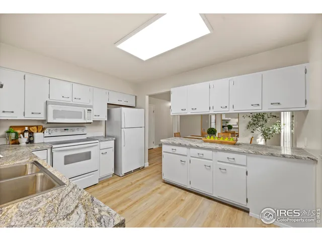 a bedroom with a bed a table and chair