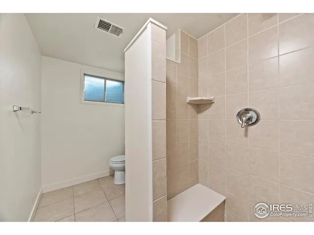 a bathroom with a toilet sink vanity and mirror