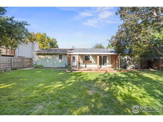 a view of a backyard with a garden and entertaining space
