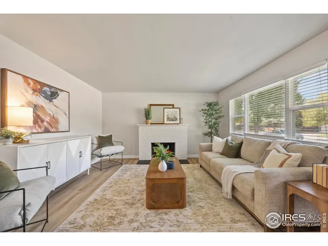 a living room with a fireplace and a potted plant