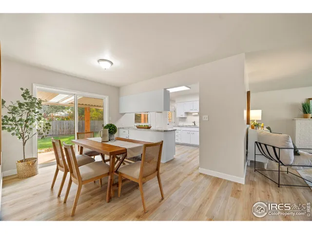 a kitchen with stainless steel appliances granite countertop a sink and cabinets with wooden floors
