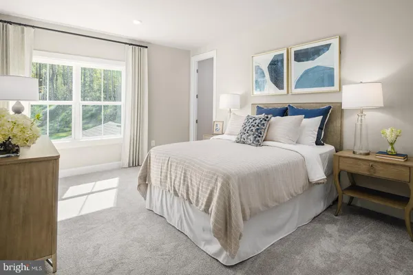 a bed room with a bed and a large window