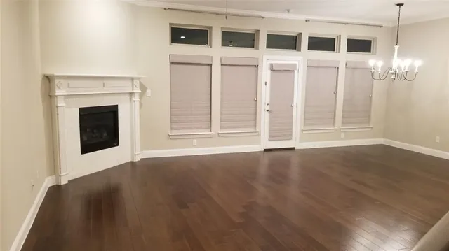 a view of a livingroom with wooden floor and a fireplace