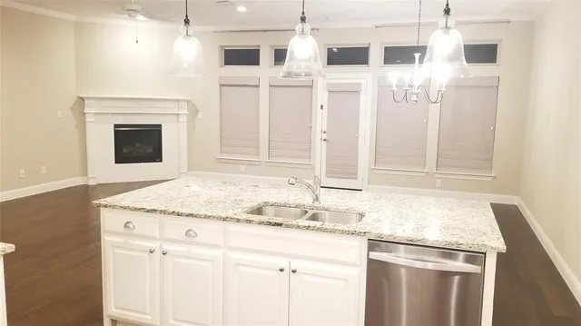 a bathroom with granite countertop a sink and a shower
