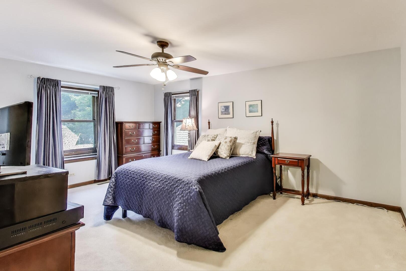 829 Shiloh Circle Naperville, IL 60540 - Photo 17 of 40 a bedroom with a large bed and a tv