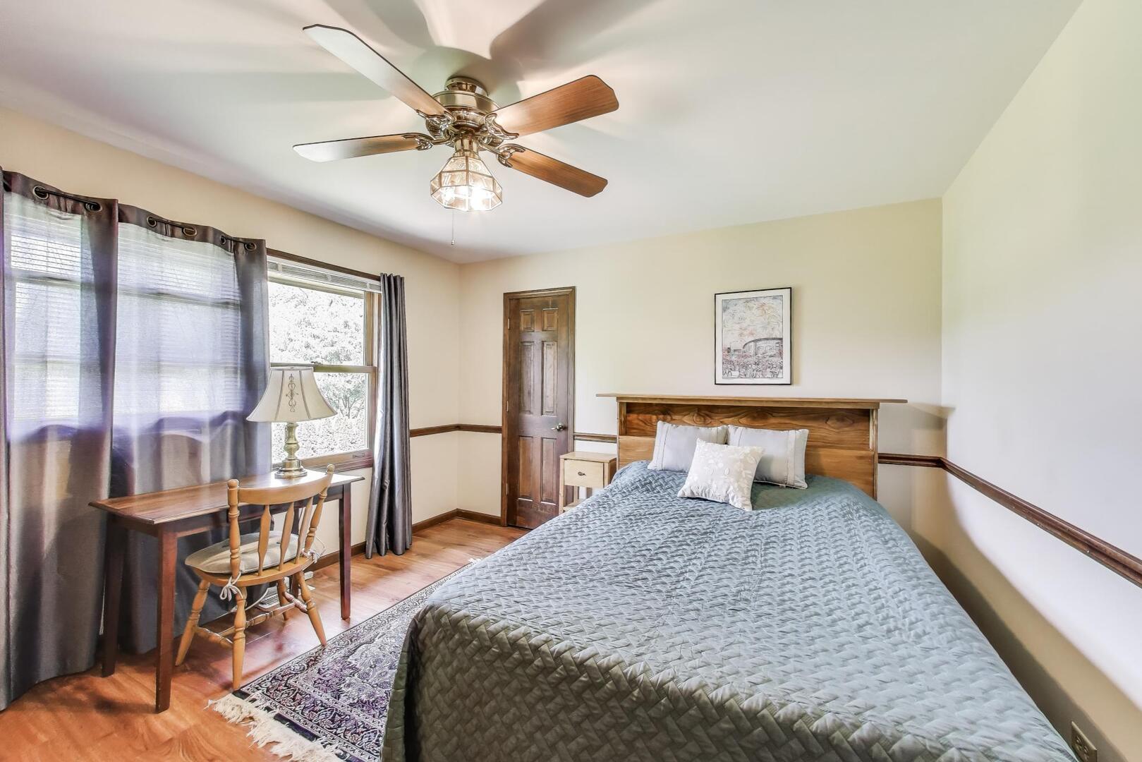 829 Shiloh Circle Naperville, IL 60540 - Photo 20 of 40 a bedroom with a bed and a chandelier