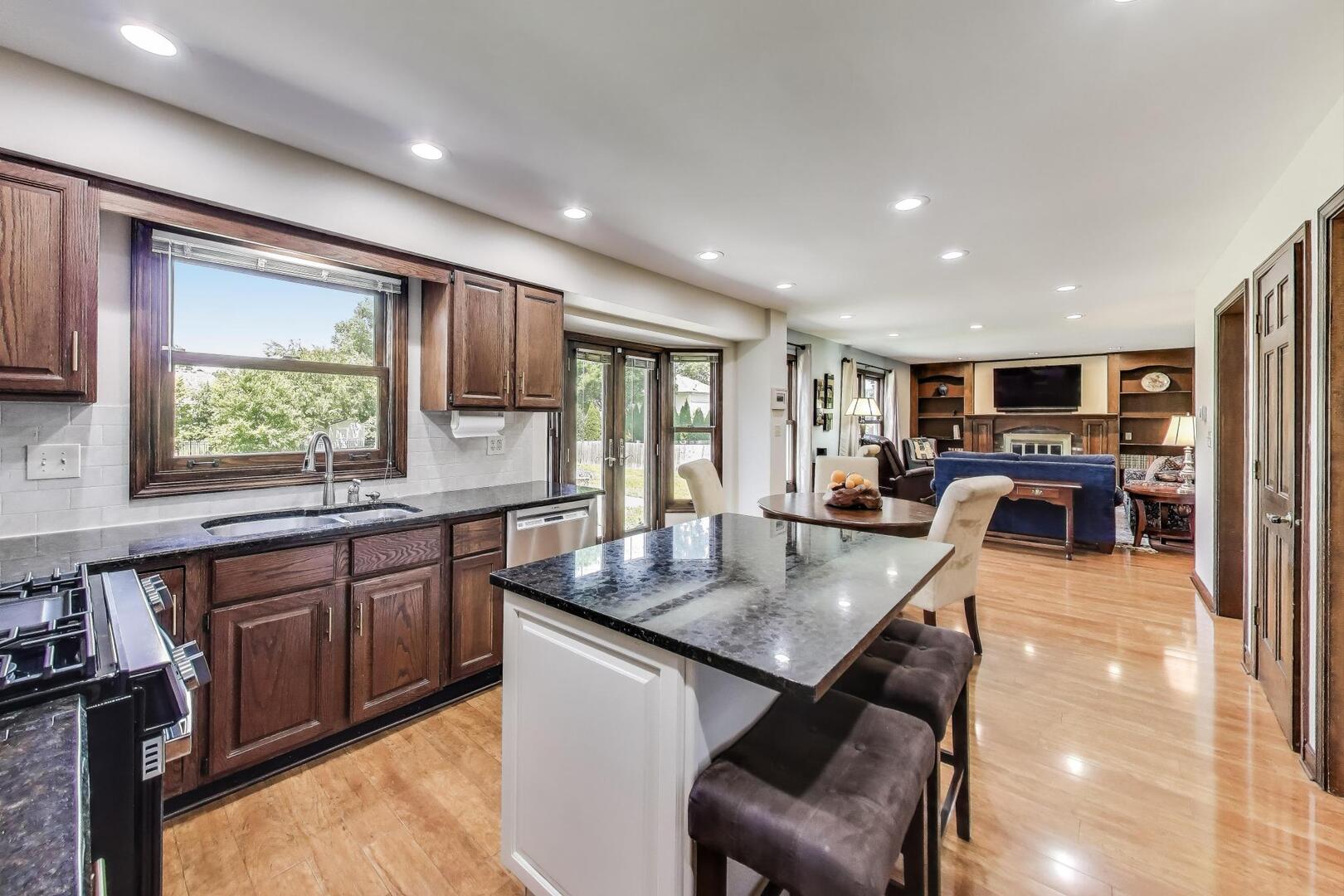 829 Shiloh Circle Naperville, IL 60540 - Photo 2 of 40 a large kitchen with granite countertop lots of counter space dining table and a large window