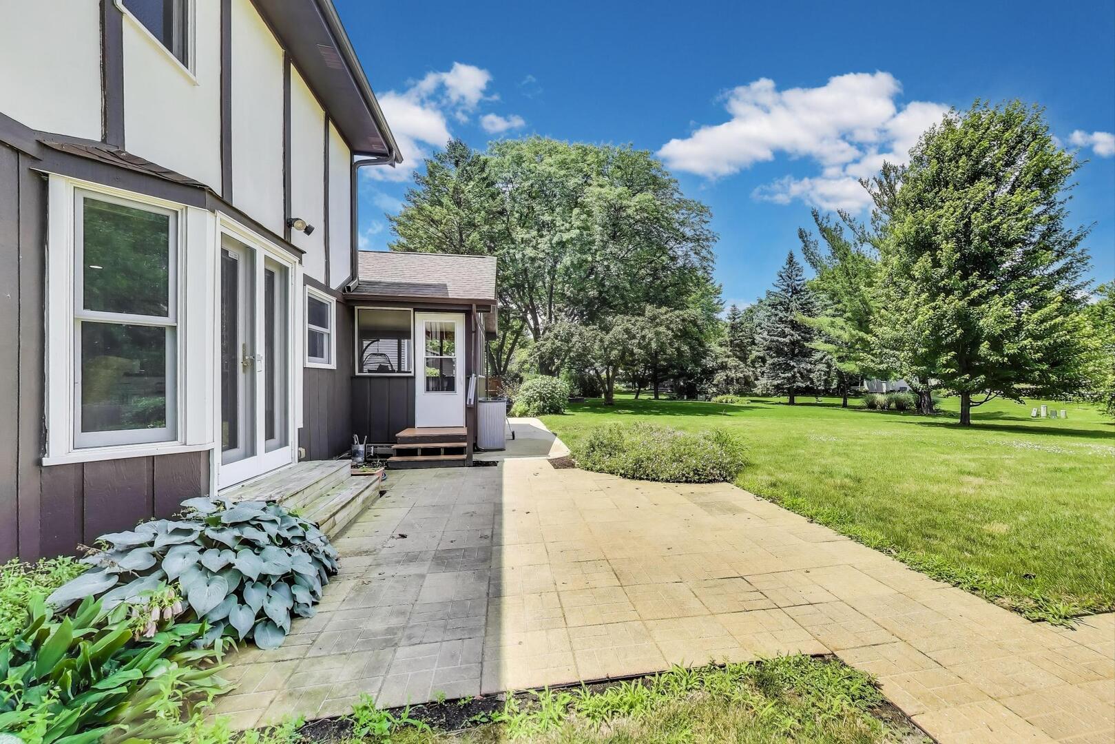 829 Shiloh Circle Naperville, IL 60540 - Photo 32 of 40 a view of a house with backyard porch and garden