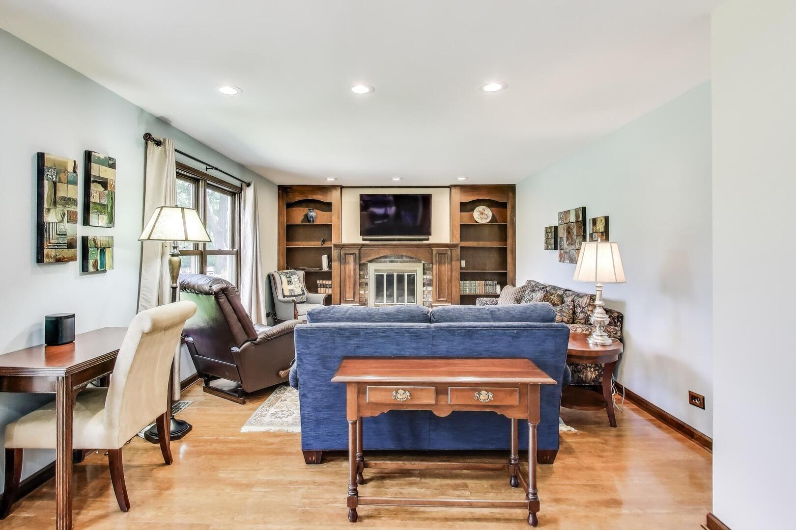 829 Shiloh Circle Naperville, IL 60540 - Photo 7 of 40 a living room with furniture a rug and a fireplace