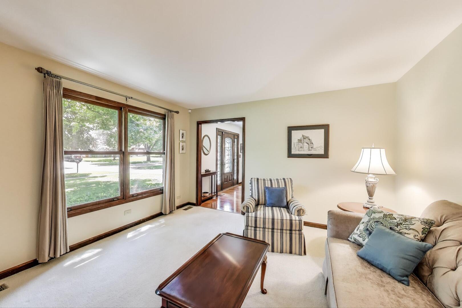 829 Shiloh Circle Naperville, IL 60540 - Photo 8 of 40 a living room with furniture and a lamp next to a window