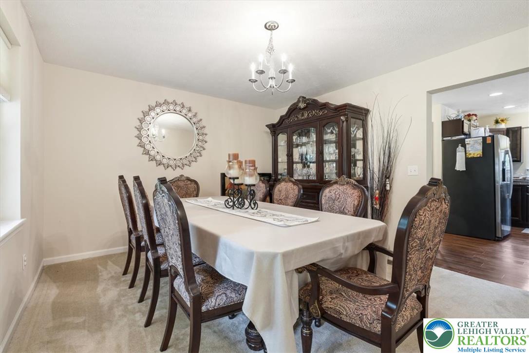 5032 Custard Road Stroudsburg, PA 18360 - Photo 31 of 80 An elegant dining room features wall-to-wall carpeting and connects smoothly to the kitchen.