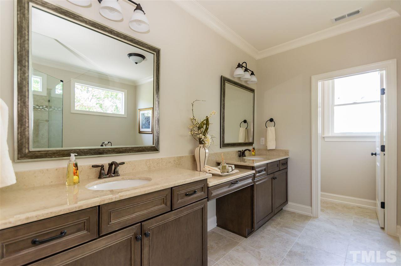 5208 Woodall Way, Unit 11 Raleigh, NC 27613 - Photo 15 of 25 a bathroom with a sink and a mirror