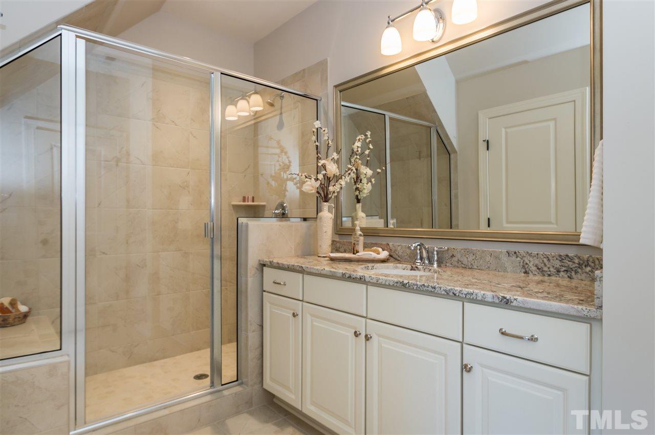 5208 Woodall Way, Unit 11 Raleigh, NC 27613 - Photo 18 of 25 a bathroom with a shower sink and mirror