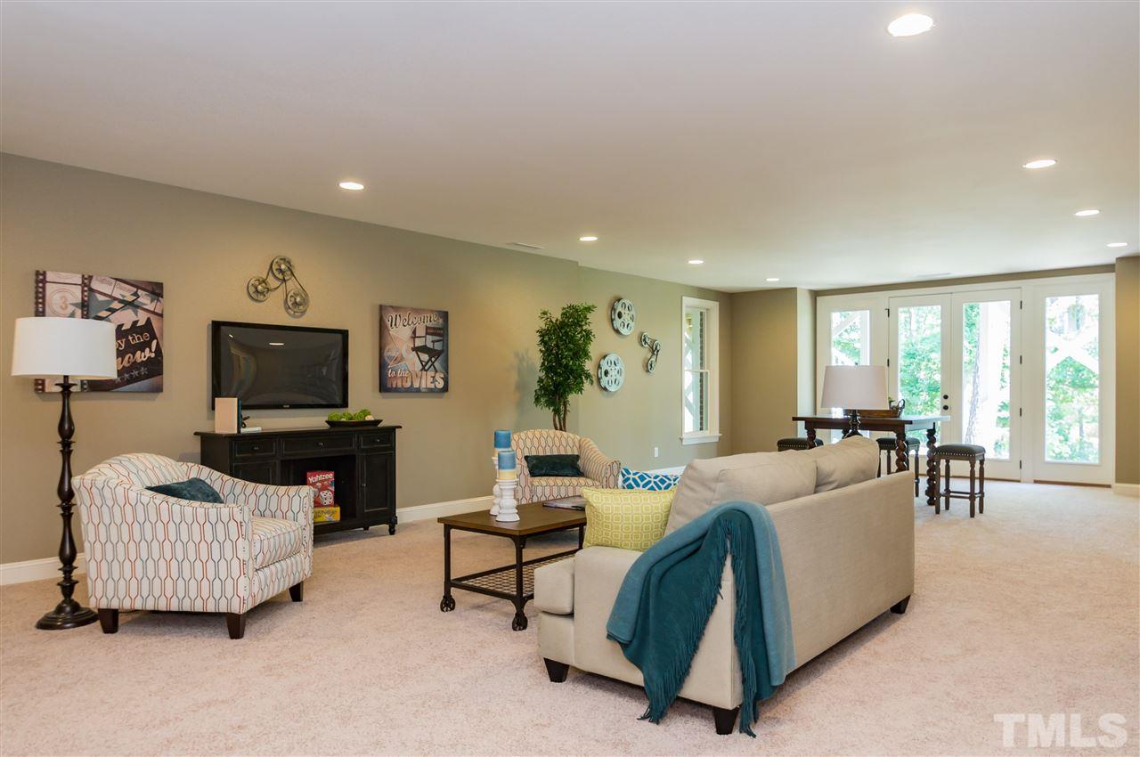 5208 Woodall Way, Unit 11 Raleigh, NC 27613 - Photo 22 of 25 a living room with furniture and a flat screen tv
