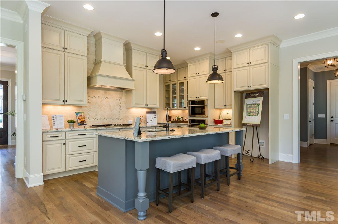 5208 Woodall Way, Unit 11 Raleigh, NC 27613 - Photo 7 of 25 a large kitchen with granite countertop lots of counter space and stainless steel appliances