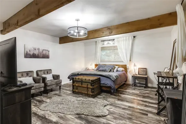 a bedroom with furniture and a flat screen tv