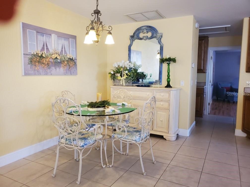 Undisclosed Address Umatilla, FL 32784 - Photo 3 of 9 a view of a dining room with furniture and a chandelier