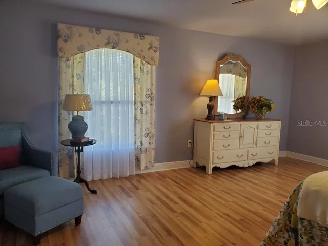 a living room with furniture and a mirror