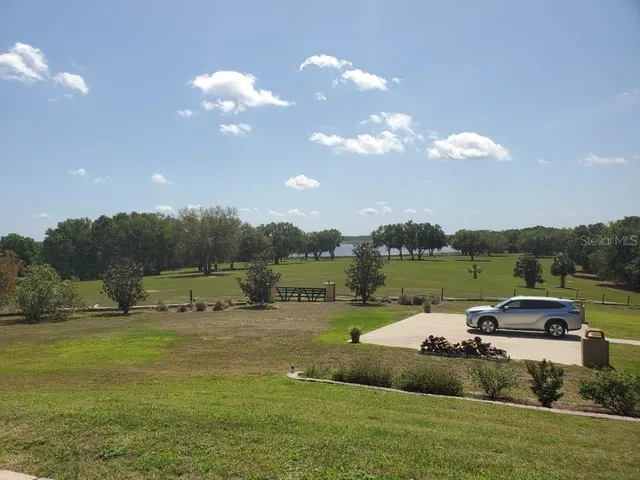 a view of a lake with houses in the background