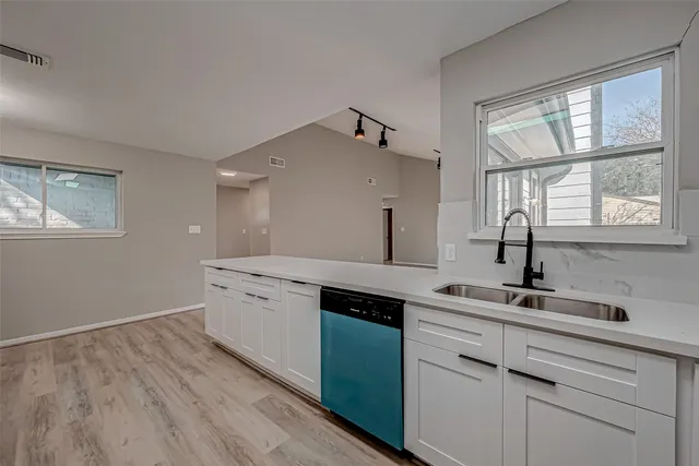 a kitchen with kitchen island a sink stainless steel appliances and cabinets