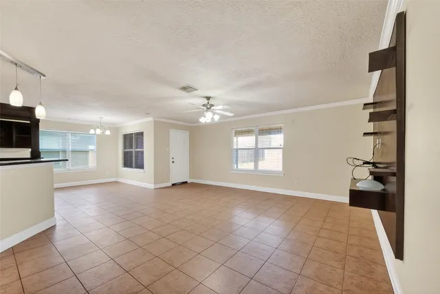 an empty room with windows and electric equipment