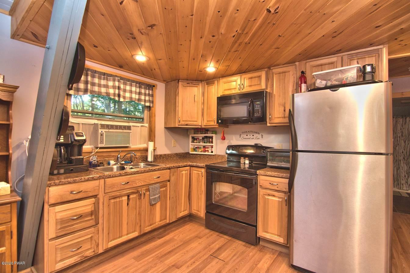 365 Welcome Lake Road Beach Lake, PA 18405 - Photo 14 of 45 a kitchen with stainless steel appliances a refrigerator and a stove top oven